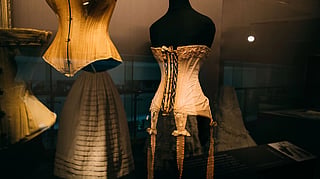 A Victorian corset displayed on a museum mannequin.