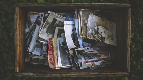 A wooden box filled with old photographs.