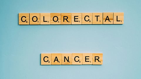 Colorectal cancer concept using Scrabble tiles on a light blue background
