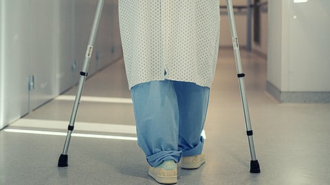 Tumor affecting the ability to walk and boy walking with the help of crutches.