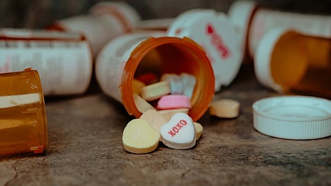 a close up of a pill bottle with pills spilling out of it