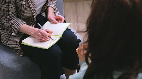 Counselor taking notes in a session