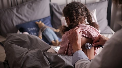 Doctor checking a child with stethoscope