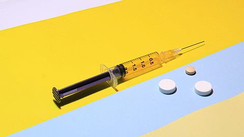 an injection with three different tablets.