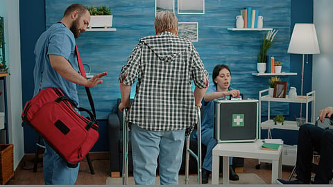 Man nurse supporting senior woman using walk frame