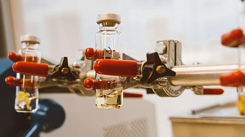 A machine holding bottles of peptide in lab.