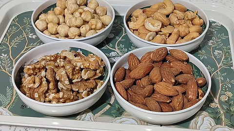 Diverse selection of nuts displayed on a decorative tray in a modern kitchen setting