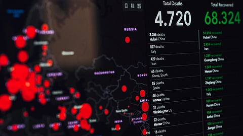 monitor showing covid-19 statistics