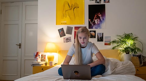 A girl watching something on Laptop.