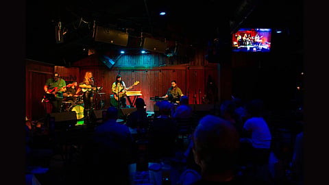 Musicians playing various instruments in a club