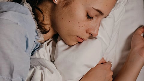 woman asleep on cozy bedsheets