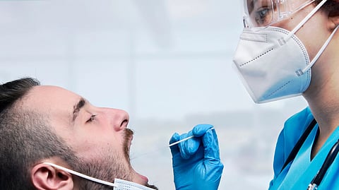 Medical professional performing swab test on a patient in a clinical setting