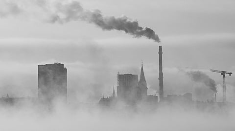 city skyline with industrial  chimney fog