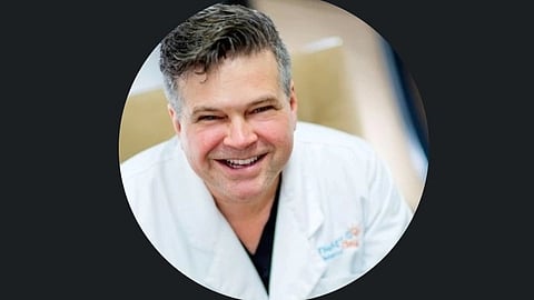 Dr. Lorentz in white coat.