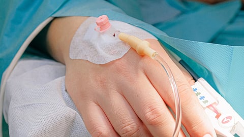A hand with a canula inserted.