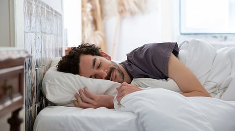 man sleeping comfortably in bed