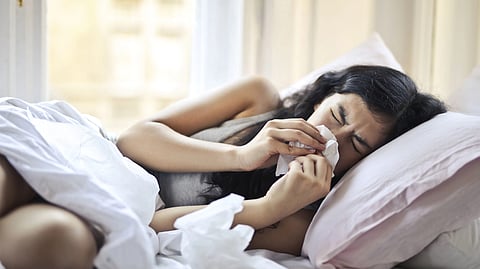 Girl with flu lying on bed