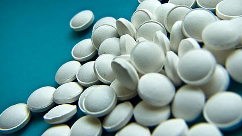 White pills on blue background.
