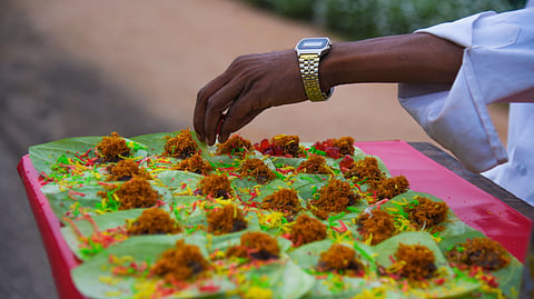 A street vendor prepares colorful paan on a tray, showcasing traditional Indian snack preparation