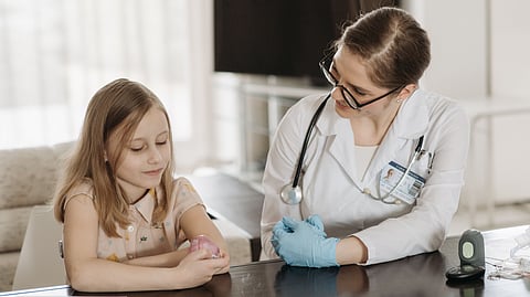 A doctor and a young girl during a pediatric check-up, fostering healthcare and trust