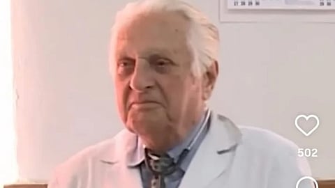 Dr. Kiril in a white coat and stethoscope around neck.