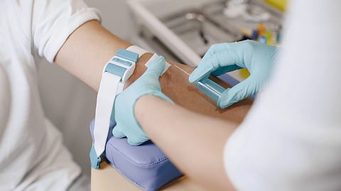 Close-up of a healthcare professional drawing blood from a patient in a medical setting