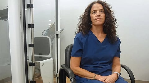 Woman sitting on a chair in a clinic setup 