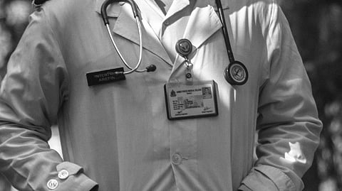 A man in a doctor's coat with a stethoscope.