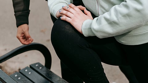 woman warming up in park during workout