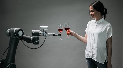 Girl raising a toast with a robot arm