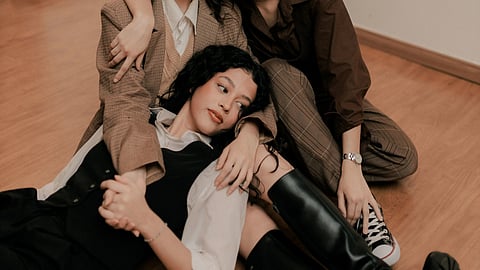 three woman laying on the floor with their arms around each other