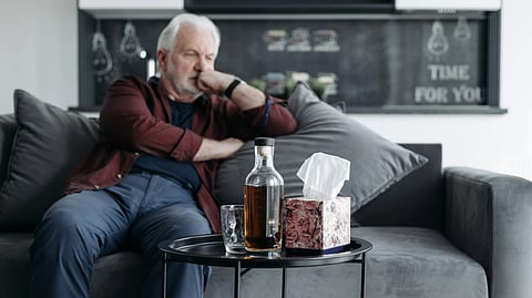 Man sitting on a couch and thinking