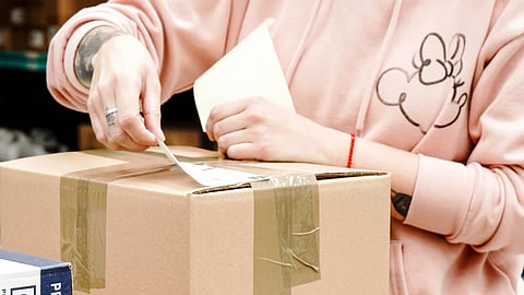 worker packing boxes in warehouse