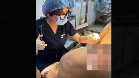 Dr. Sudeshna while suturing with needle and thread and patient in front.
