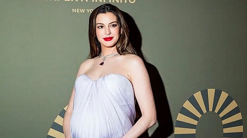 Portrait of Anne Hathaway with a baby bump