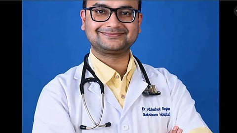 Dr. Ranjan in white coat and stethoscope around neck.