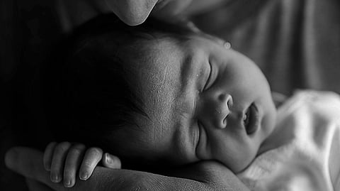 a newborn baby with their parent