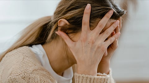 Patient with anxiety holding her head