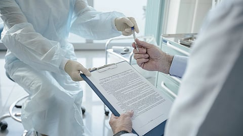 doctor handing over a document