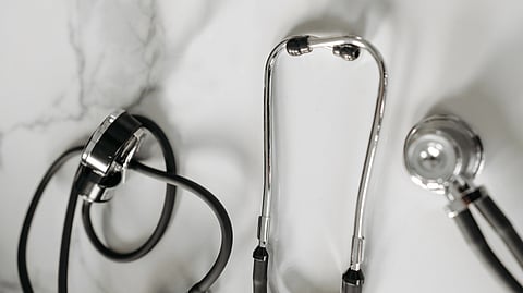 black and silver stethoscope on white surface