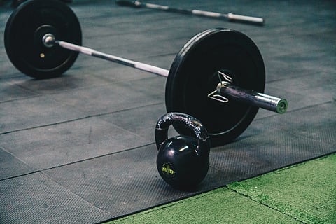 barbell and kettle bell on a black mat