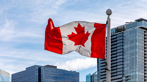 Canadian flag hoisted over a building