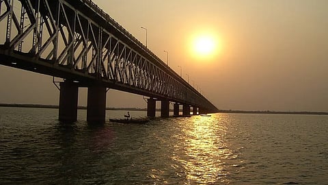 Godavari River and bridge on top with the sun in the sky.