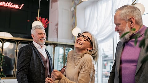 2 old men and 1 old woman laughing together.