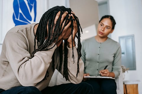 A young couple in a serious indoor discussion, dealing with relationship issues and emotions