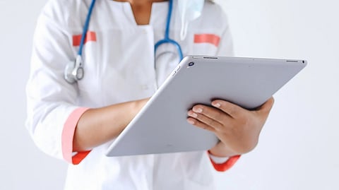 A doctor using a tablet and digital authentication.