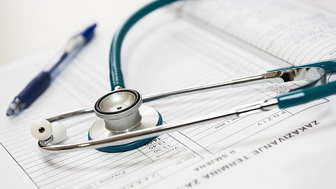 A stethoscope kept over diagnostic report