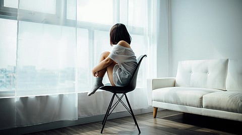 Stressed woman sitting on a chair