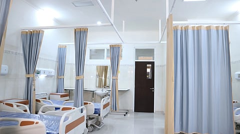 Clean and modern hospital ward with beds and privacy curtains in Surabaya, Indonesia