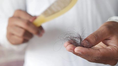 person holding hair 
